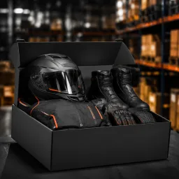 Packed motorcycle gear ready for shipping in matte black boxes